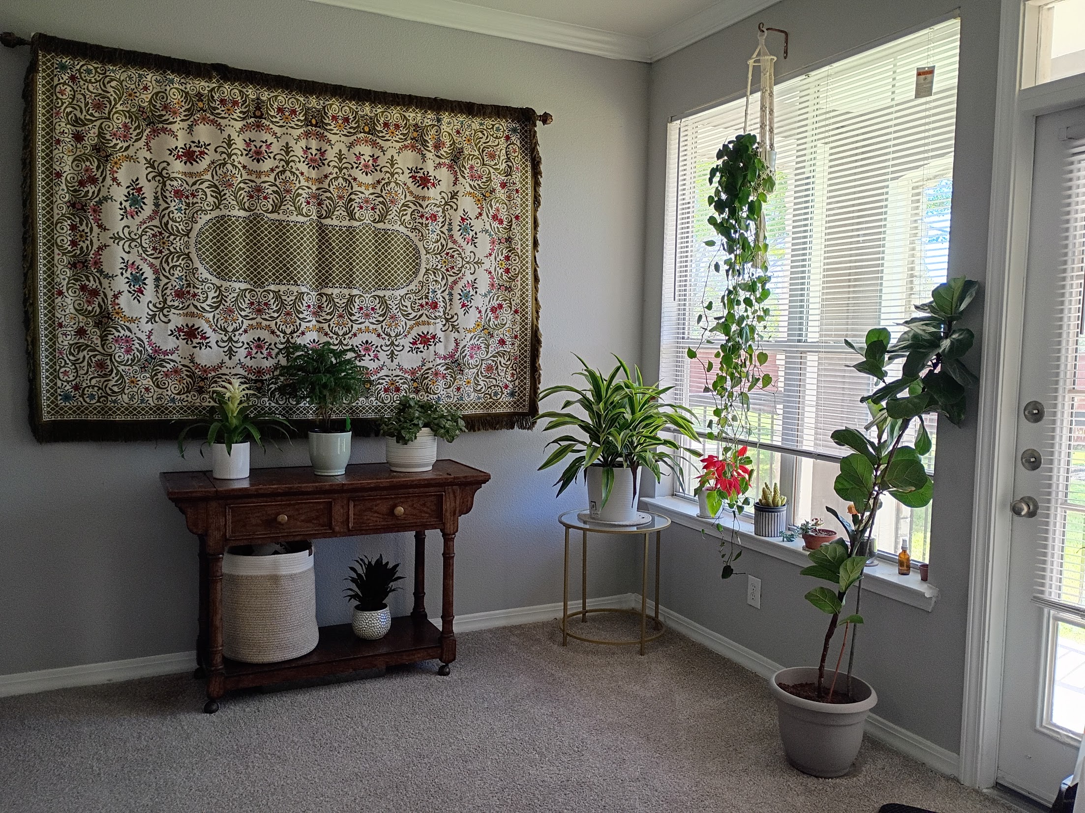 Vase with greenery on table